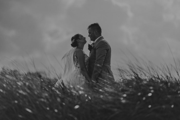black and white wedding portrait couple in tall grass