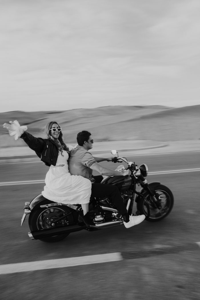 bride and groom riding on motorcycle