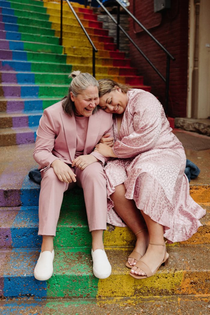 same-sex couple on rainbow stairs 