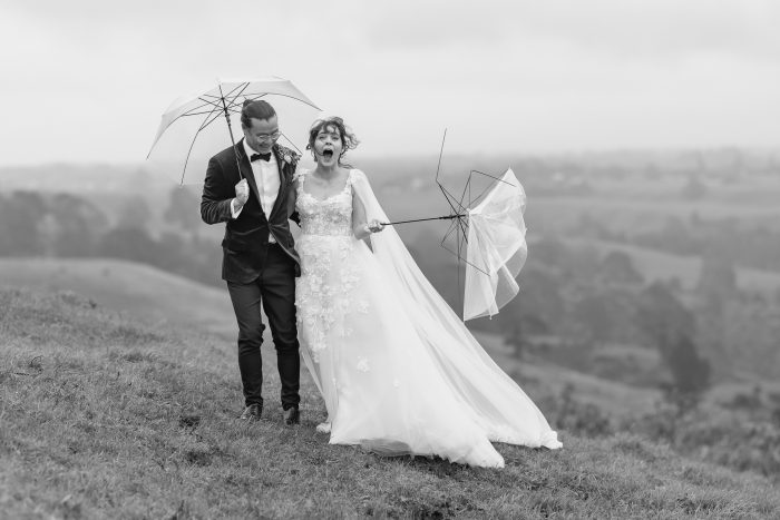 rainy and windy wedding day breaks bride's umbrella