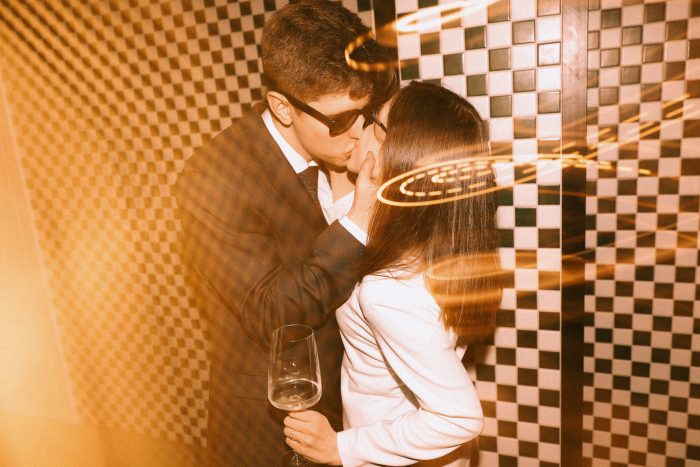 vintage-inspired portrait couple kissing with flash