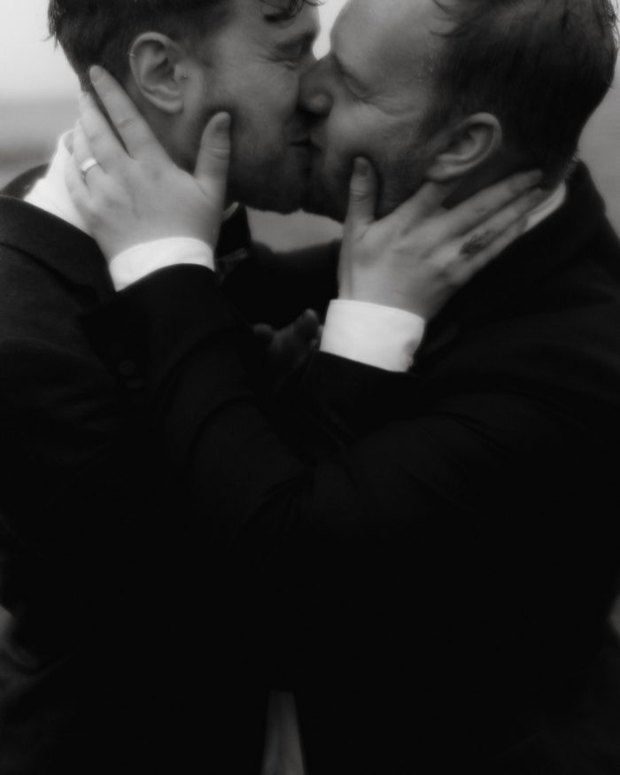 same-sex couple kissing on wedding day