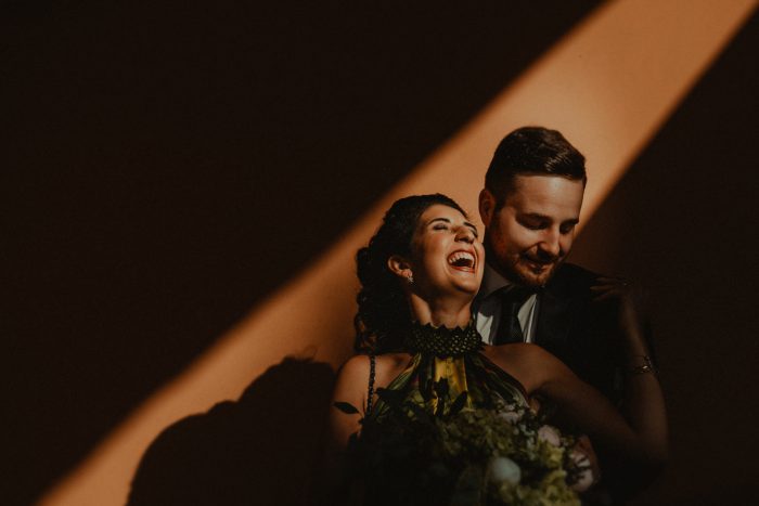 wedding couple smiling in ray of light