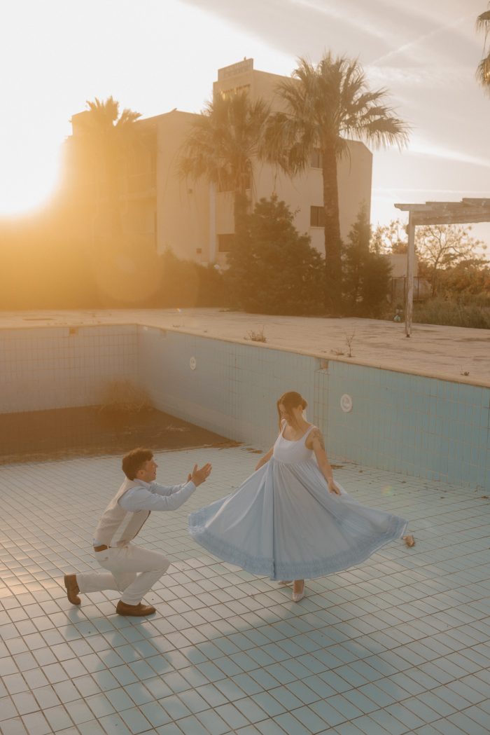 bride and groom dancing in abandoned swimming pool