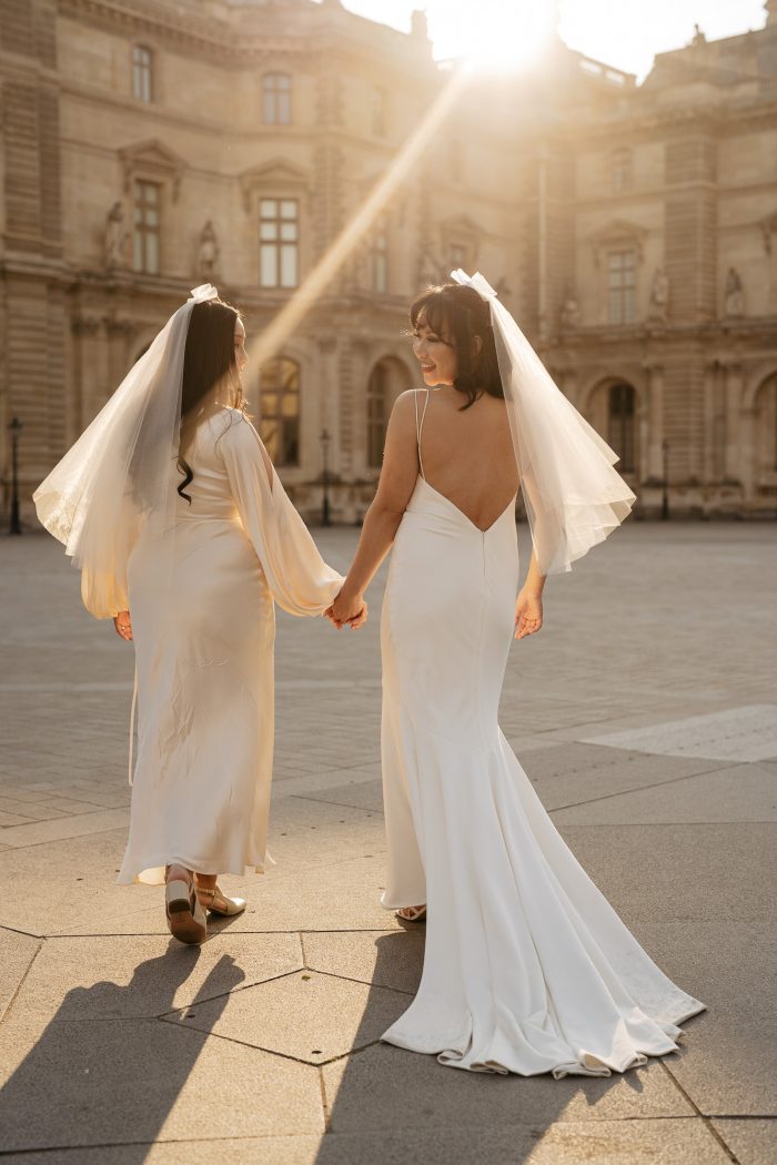 two brides walking on paris street 