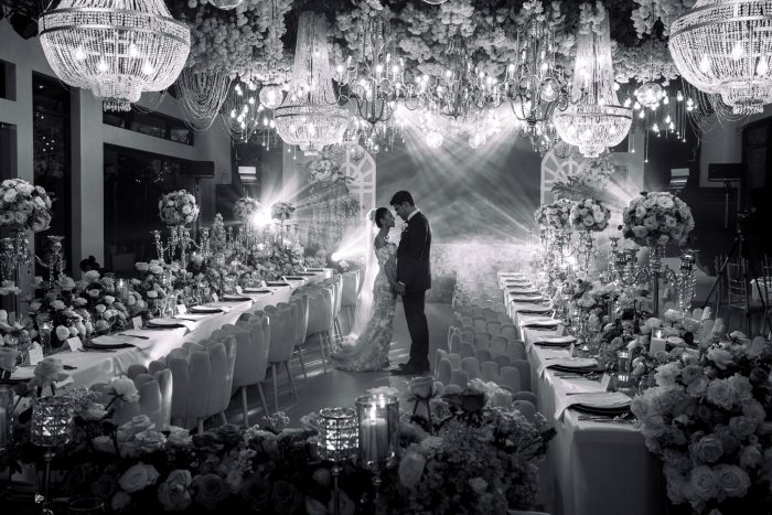 black and white photo of wedding couple in decadent ballroom
