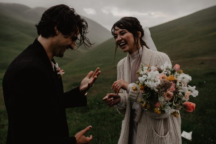 couple laughing in the rain during their Italian elopement