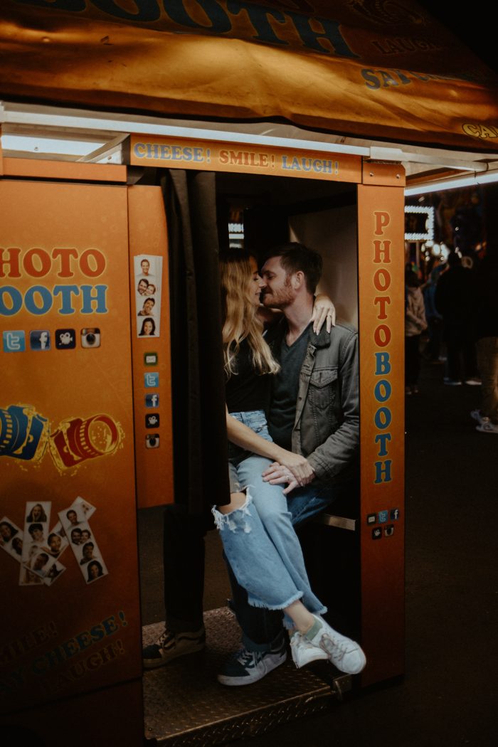 couple kissing in a photobooth