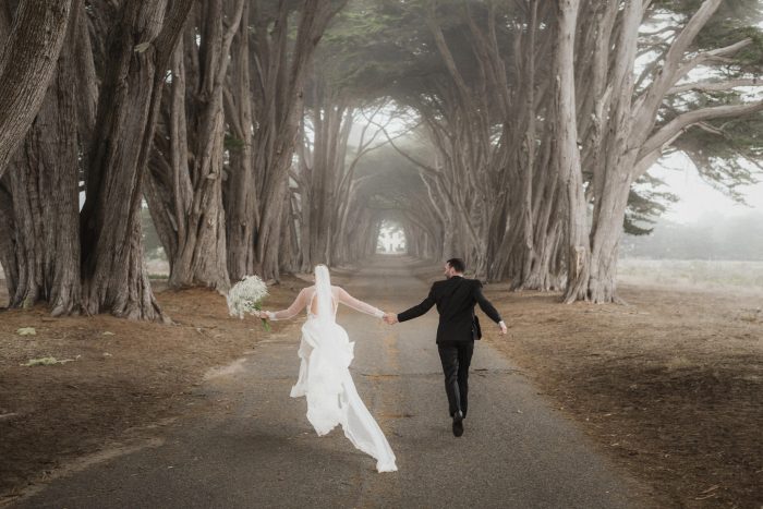 wedding couple running through Cypress Tree Tunnel, Pt Reyes California