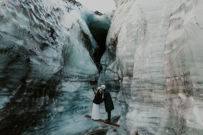 adventurous wedding couple inside icy cave