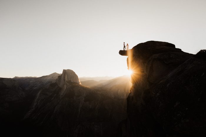 epic landscape couple posing on Yosemite peak