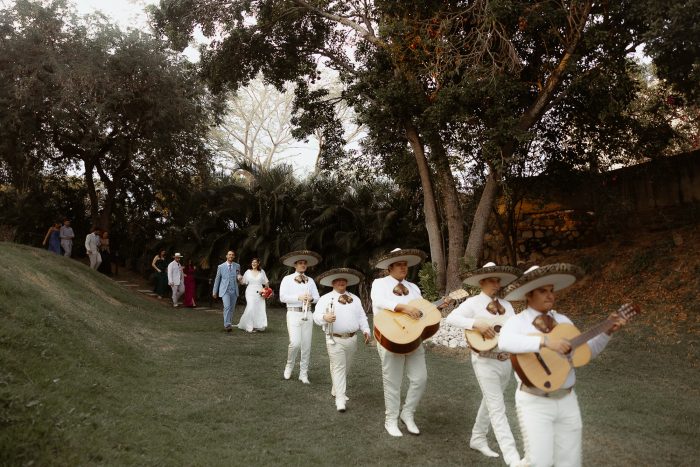 wedding couple being lead by a mariachi band