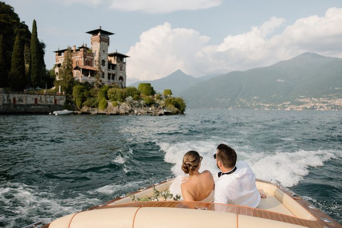 wedding couple riding on boat in Italy