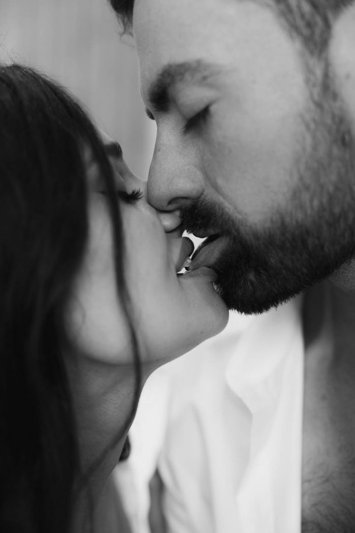 black and white photo couple intimately kissing