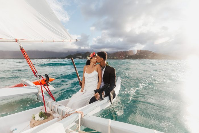 couple on a catamaran in hawaii